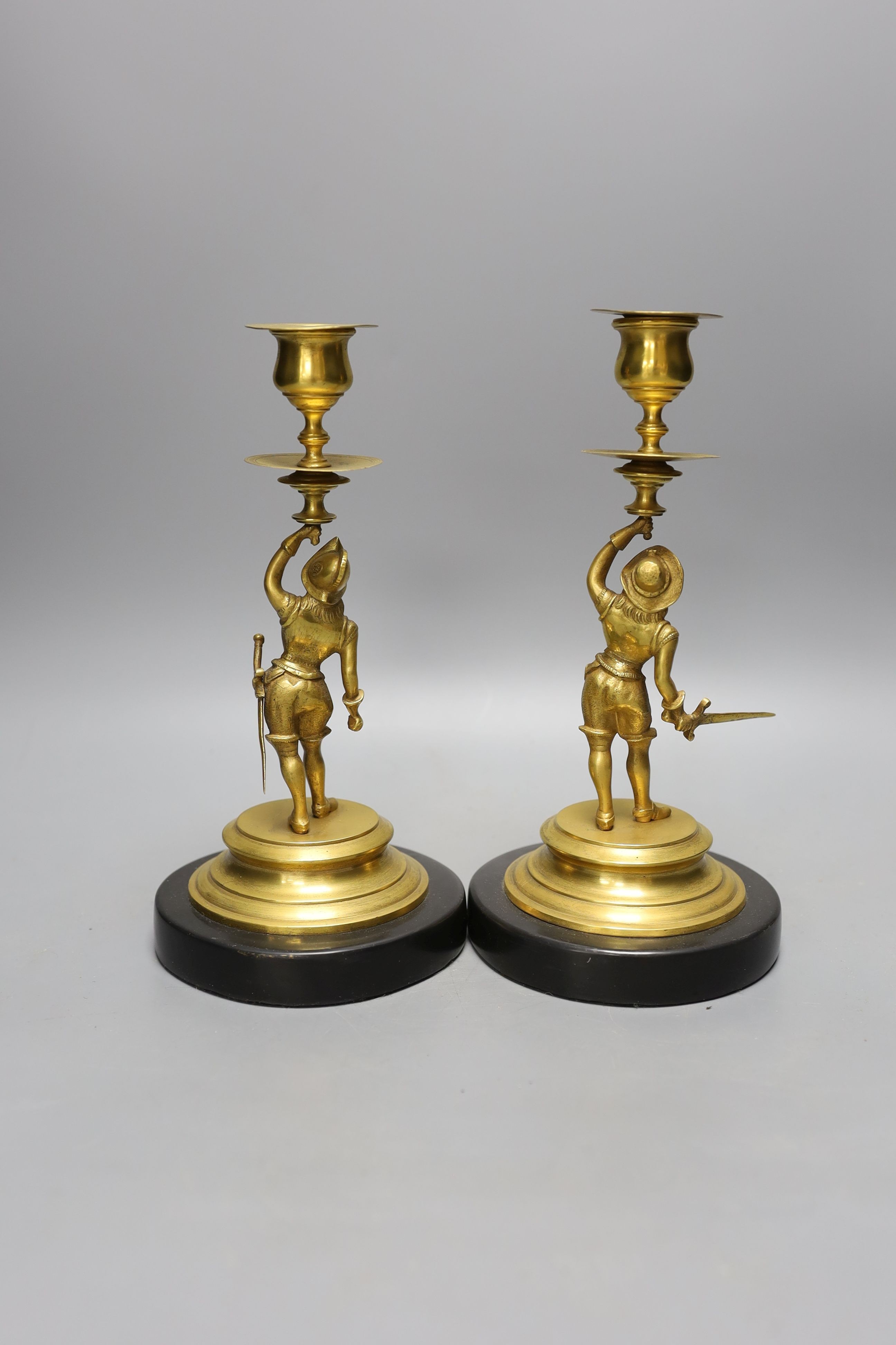 A pair of gilt metal ‘cavalier’ figural candlesticks, 24cm